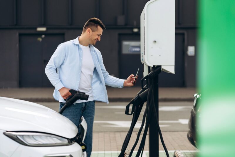 Image showing the EV charging payment system with a dashboard on a laptop, mobile app integration, and a contactless payment terminal for card transactions, ensuring seamless payment for users.